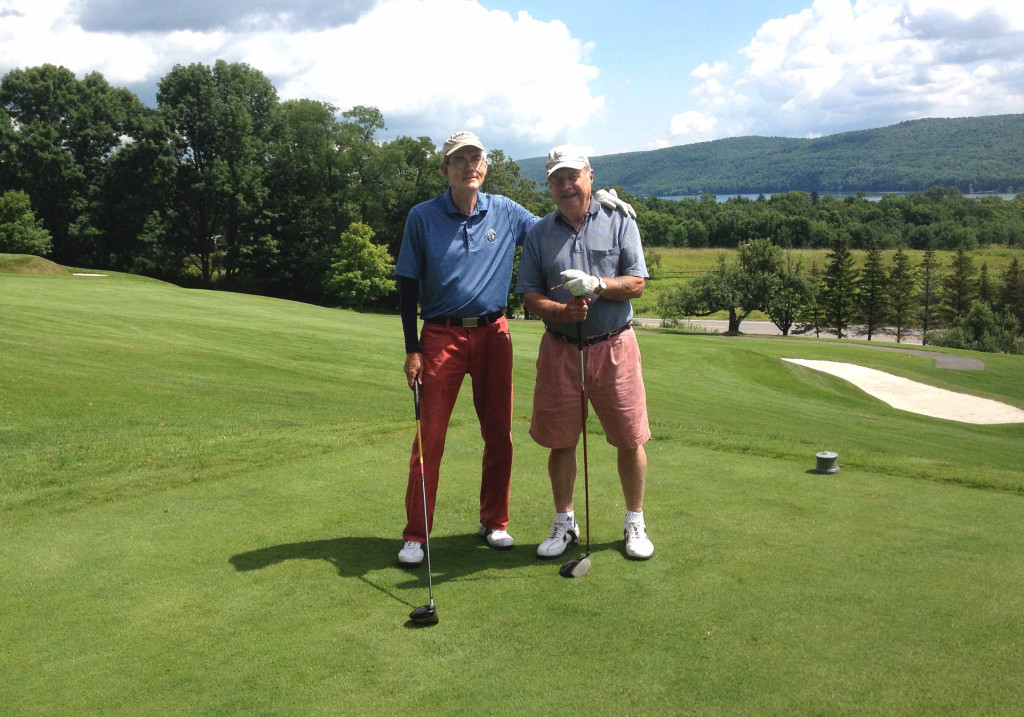 Bill Coleman of Pierstown, right, hit his first-ever a hole-in-one at about 11 a.m. yesterday on the ninth hole of The Otesaga's Leatherstocking Golf Course.  Here, Tim Feury of Cooperstown, who was playing with Bill and Bill Glocker, offers congratulations. "We knew he hit a good shot," Glockler recounted, "but we couldn't see it go in the hole because of the ninth green being elevated and it disappeared over a slight rise on the green."  When the trio got to the green, they discovered Coleman's ball in the cup.  It played 158 yards to an elevated green, so it was playing like 165-70," said Glockler. "It was very exciting and his first hole-in-one." (Bill Glockler photo)