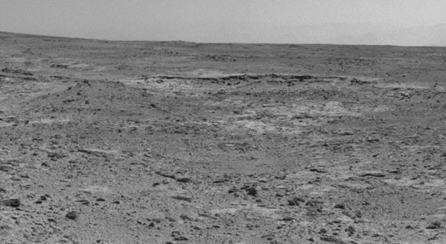 The low ridge that appears as a dark band below the horizon in the center of this scene is a Martian outcrop called "Cooperstown," a possible site for contact inspection with tools on the robotic arm of NASA's Mars rover Curiosity. The ridge extends roughly 100 feet (about 30 meters) from left to right, and it is about 260 feet (about 80 meters) away from the location from which Curiosity captured this view. 