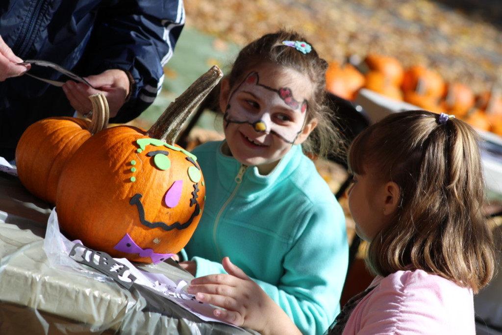 Roza Massarotti, Schenevus, and Kiera Dominoski, Oneonta, finish decorating their pumpkins at the annual Pumpkins In The Park, a fundraiser for the St. Mary's food bank. The even featured carnival games, a pet parade, baked goods, a wreath raffle and more. The even goes until 4pm. (Ian Austin/AllOTSEGO.com)